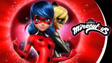 A female superhero with blue hair and a red suit in front of a superhero male wearing a black cat suit.