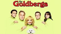 a family of 5 plus a white dog on a yellow background with the Goldbergs words