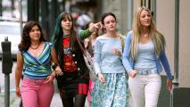 Four young women walking down the street.