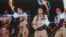 4 men in overalls zapping something with guns